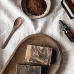 Handmade soaps and bowl with coffeee placed on table